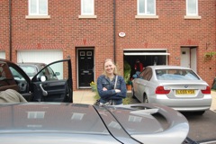 Sarah in front of her house